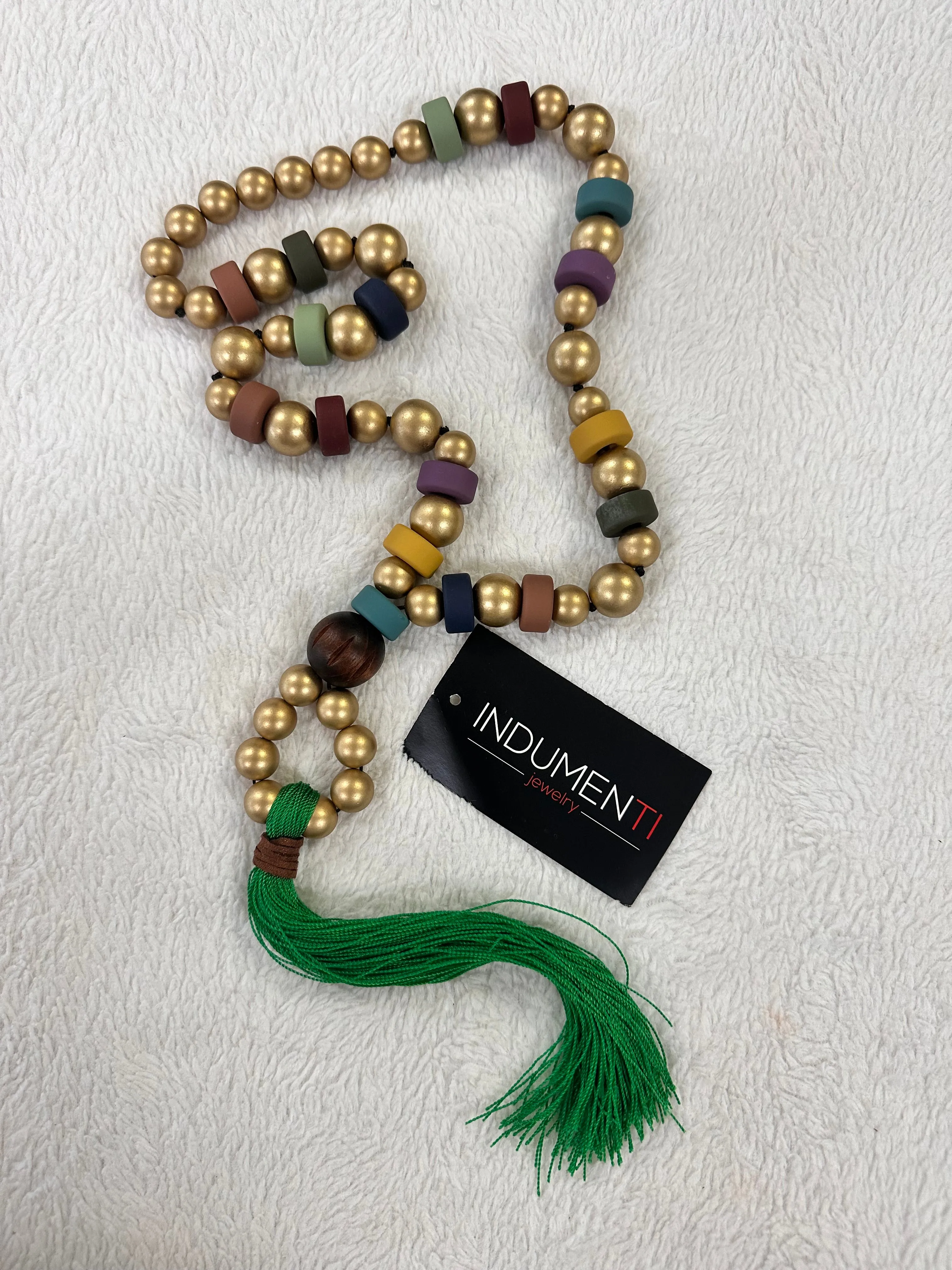 Plus gold with green tassel